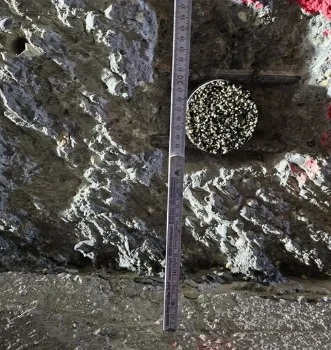 Installed sensor in a drilled hole on dark ground