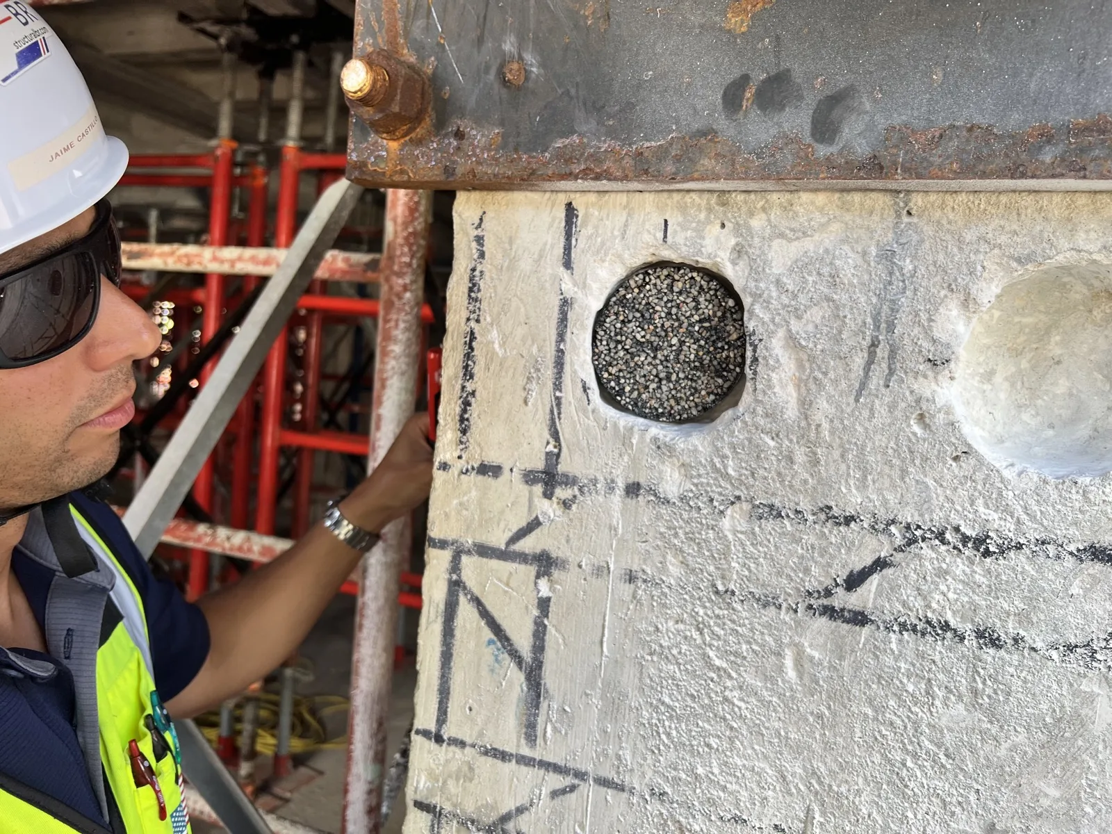 Infrasolute employee inspecting a bridge component on site