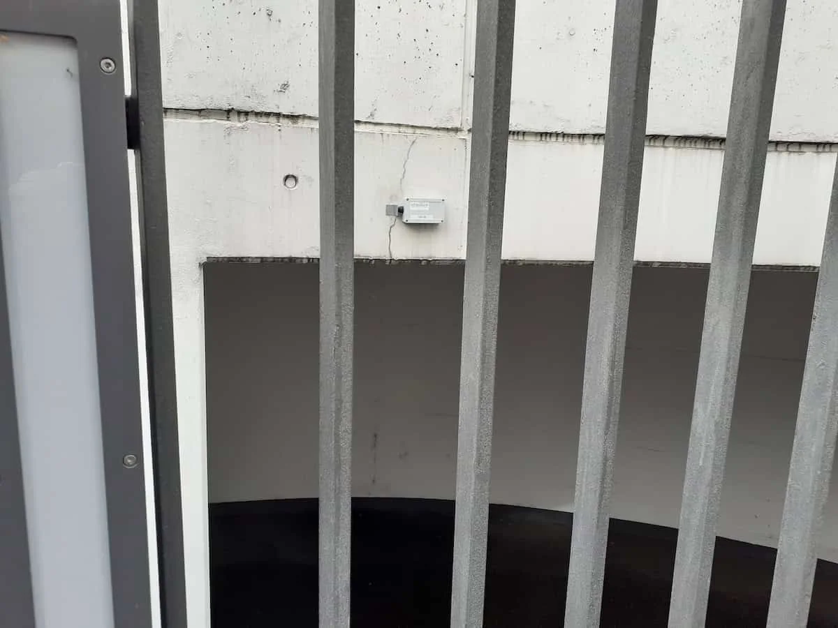 Sensor on the concrete wall above the entrance to the underground car park, the crack runs towards the mounting point